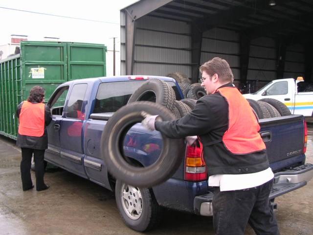 workers off load tires