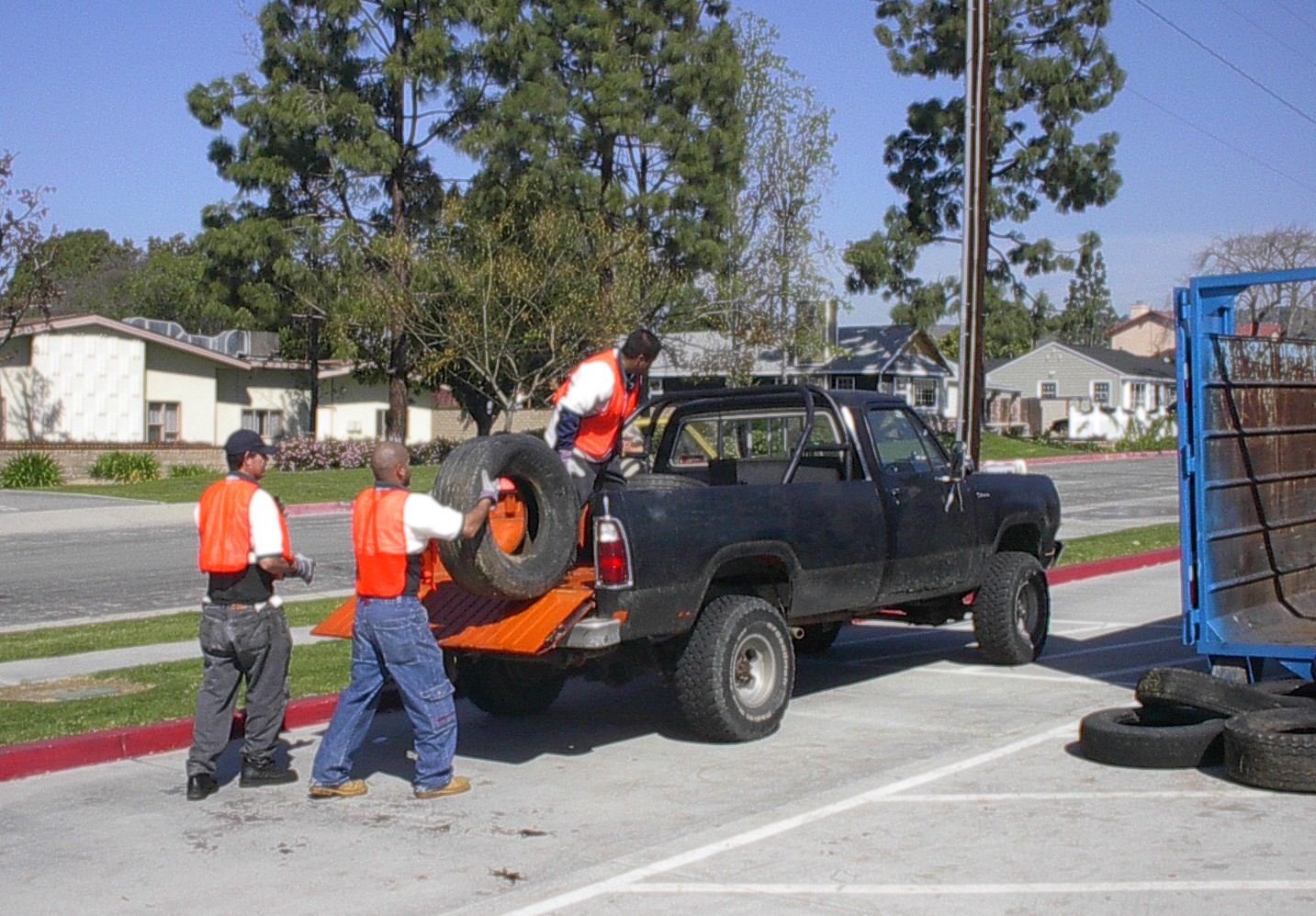 workers unload tires from a truck