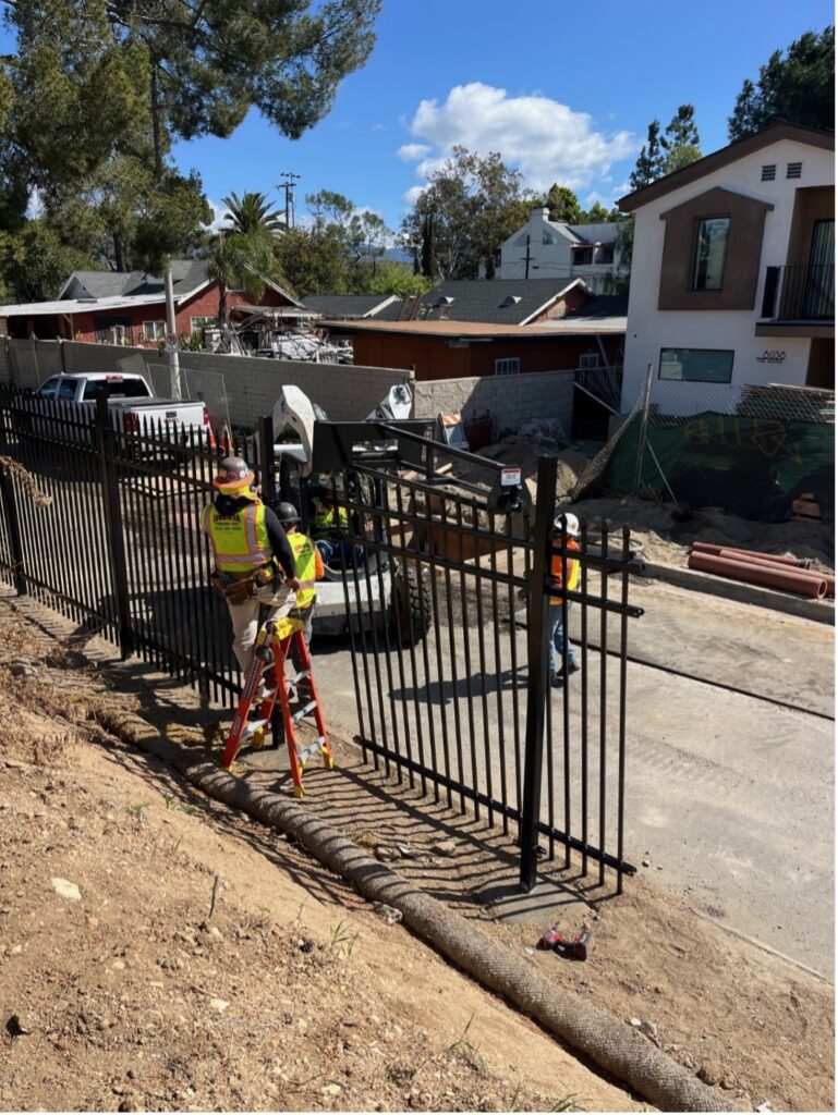 Workers installing steel fencing