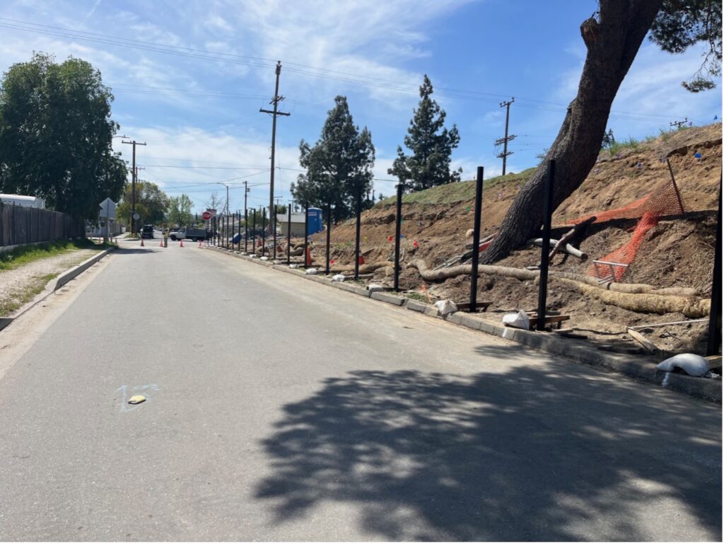 View of steel polls set into concrete along the curve