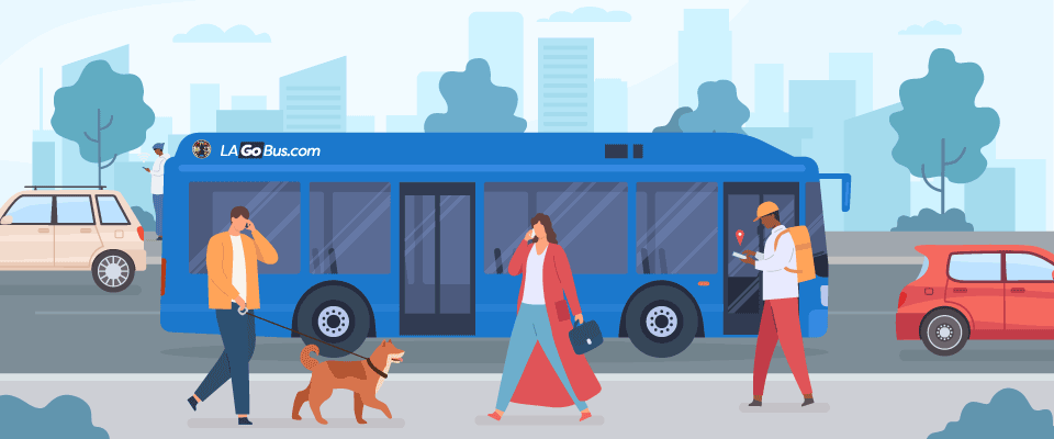 LA branded bus driving through a street with people walking by