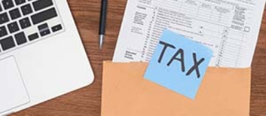 Image of tax form near laptop