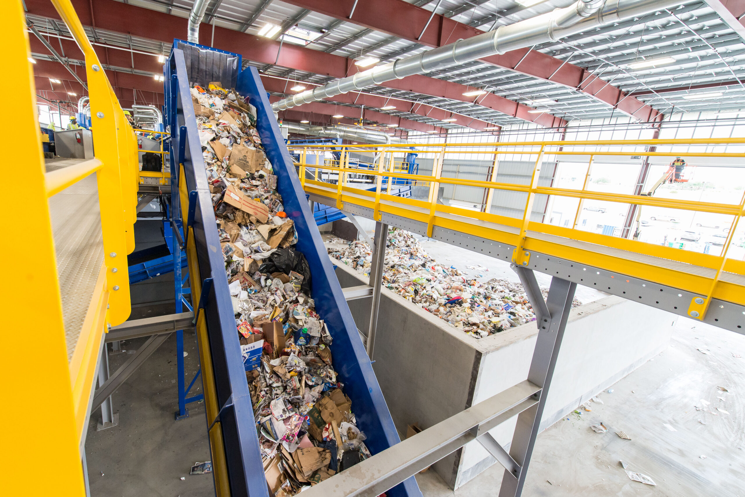 Conveyor filled with recycled materials flowing down.