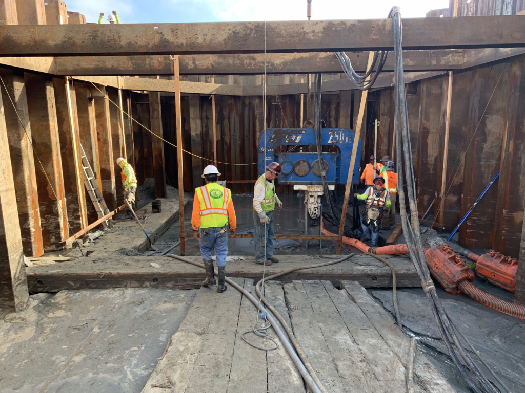 Construction site of Alamitos Bay Pump Station with workers and heavy machinery