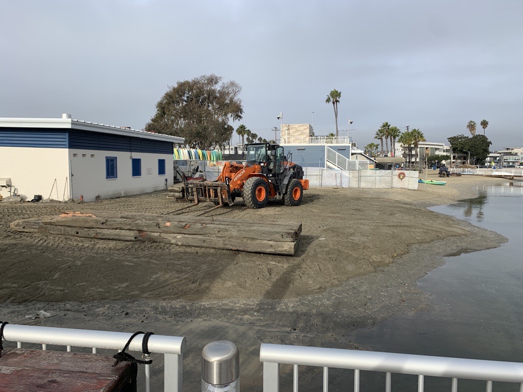 A heavy duty forklift at Alamitos station moving a pile of lumber