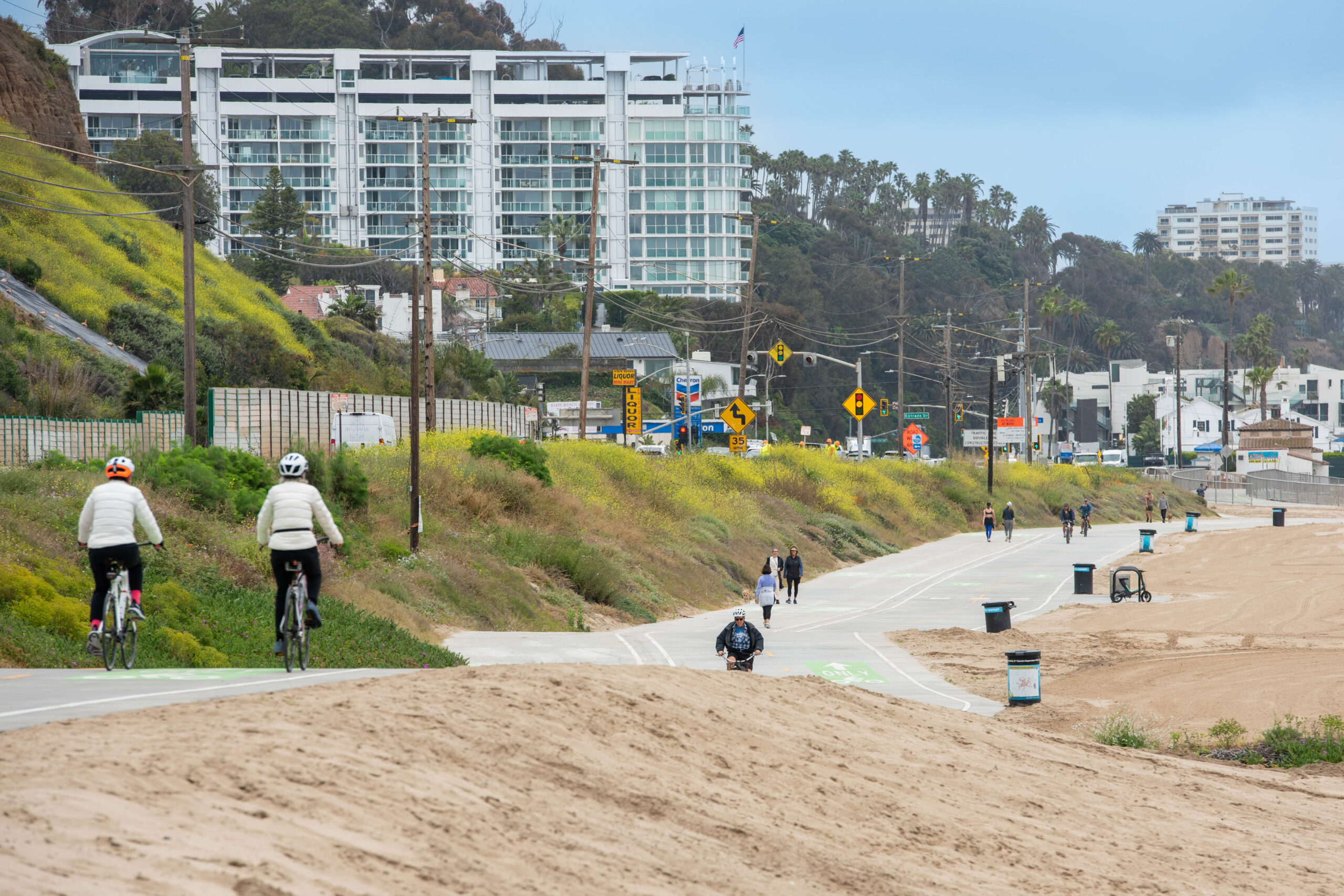 View of a bike trail next to a road and sandy area