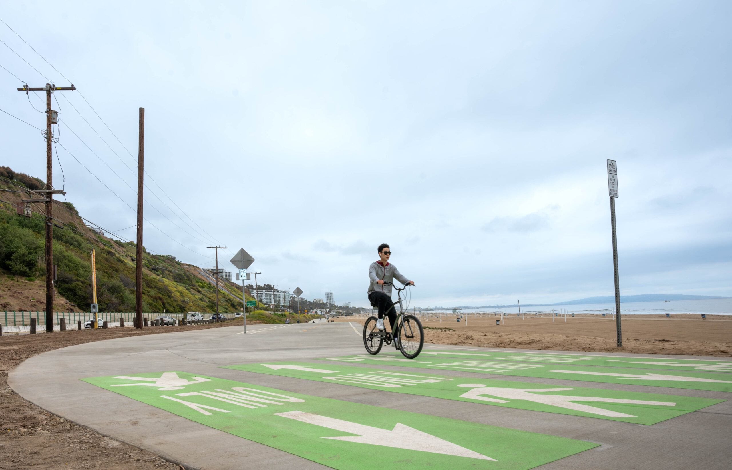 Picture of biker on a bike trail next to a beach